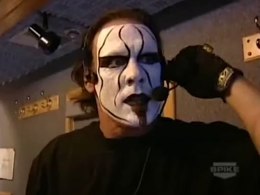 Sting, the wrestler, in full face paint wearing a headset microphone. 