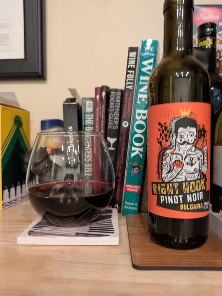 Red wine next to half bottle 