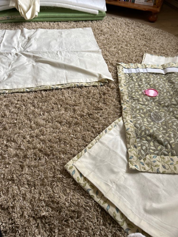 Four small curtains work in progress on the lining with recycled old school fabric. In the background are some bench cushions being reshaped and dressed. 