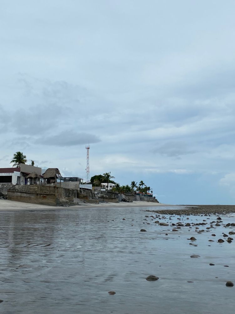 a photo of a coast in a beach where you can see some houses 