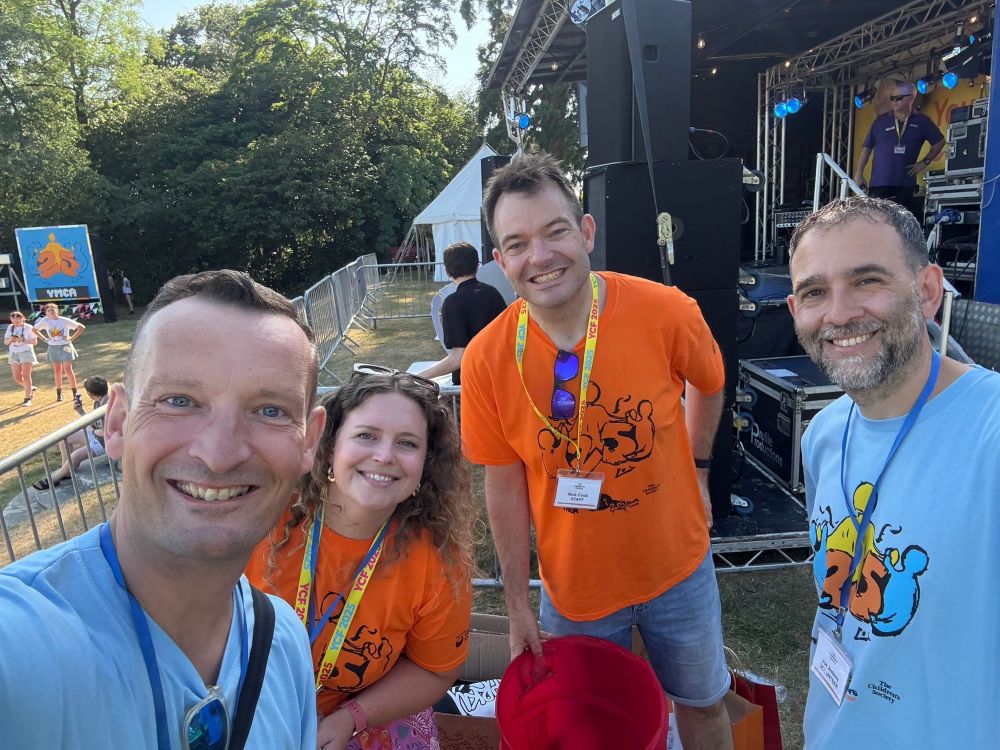 Photo of 4 volunteers at festival 