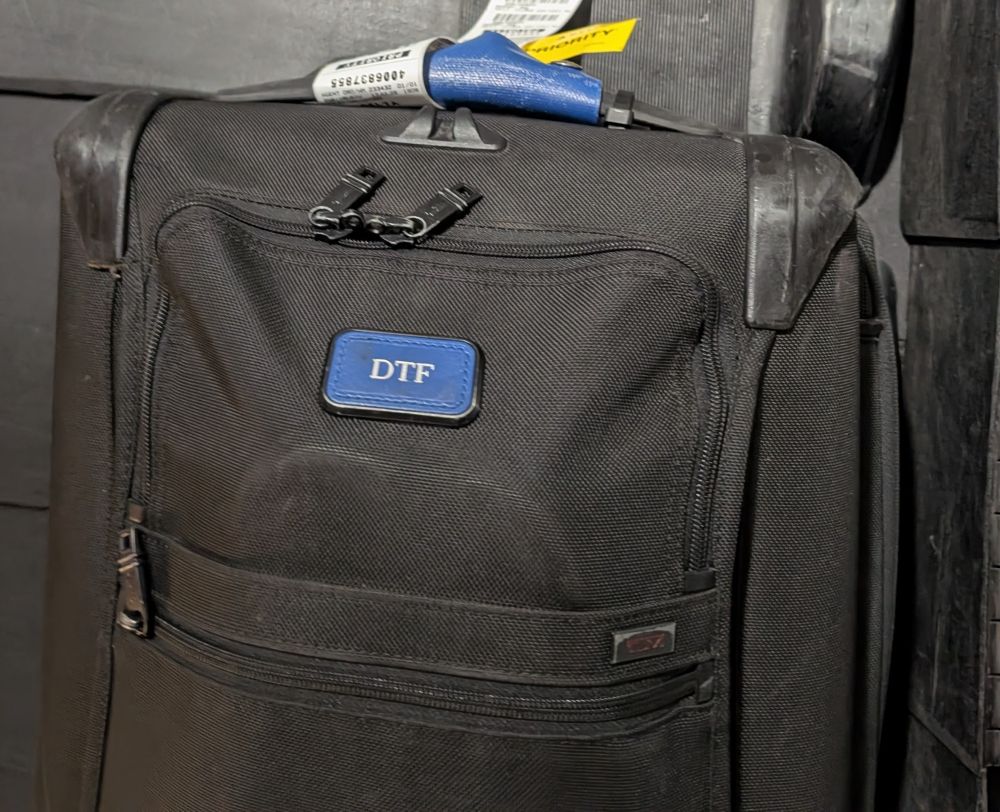 Monogrammed luggage with the initials "DTF"