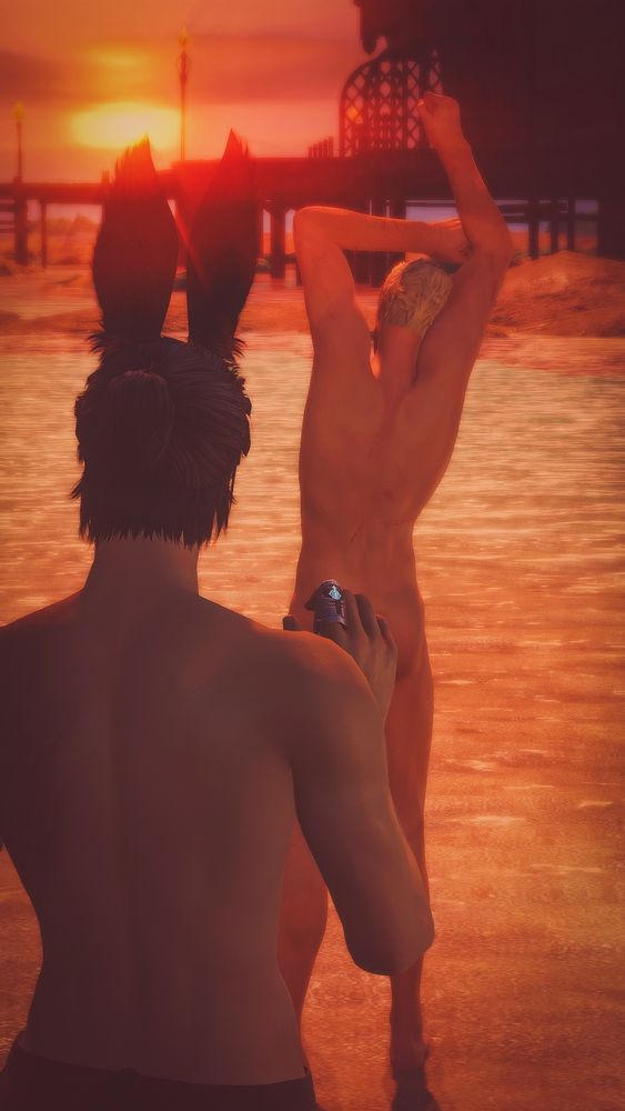 A gpose of Casca and Nero on the beach. Their backs are to the camera as Casca stands a bit behind Nero, staring at him, whilst Nero stretches, standing in ankle deep water.