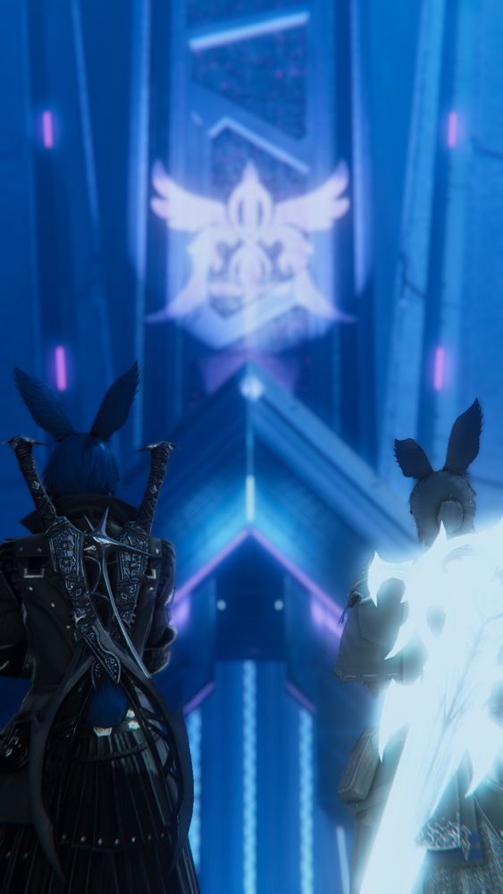 A gpose of Casca and Stargazer in Solution 9 looking up at a tall skyscraper that had the Alexandria logo on it. The camera is focused on Casca and Stargazer, blurring the logo.