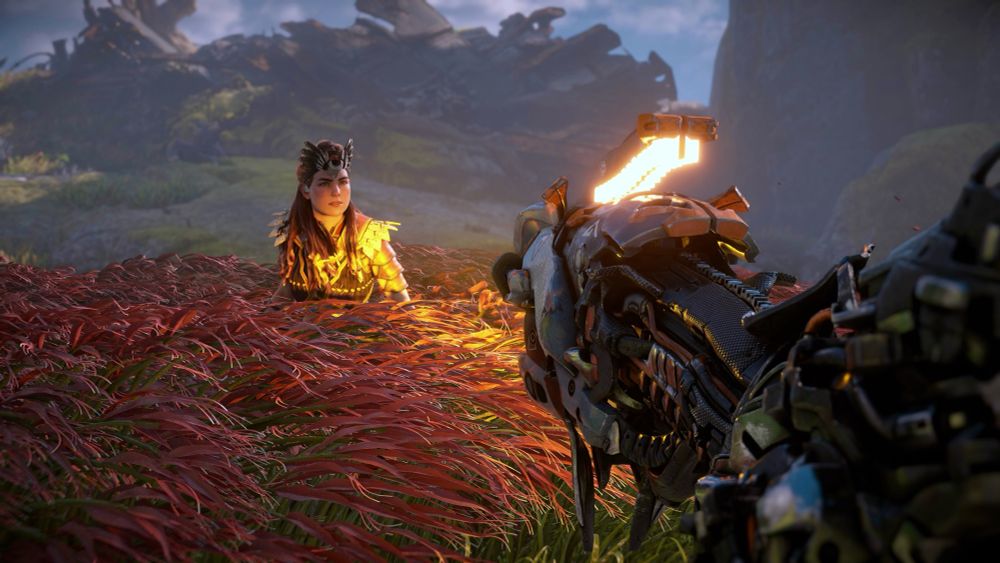 Horizon zero dawn Aloy lit by the yellow light of a watcher in the foreground 