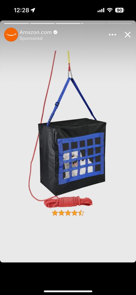 Screenshot of an Amazon ad with a dog in a plastic box with bars on one side being suspended in the air