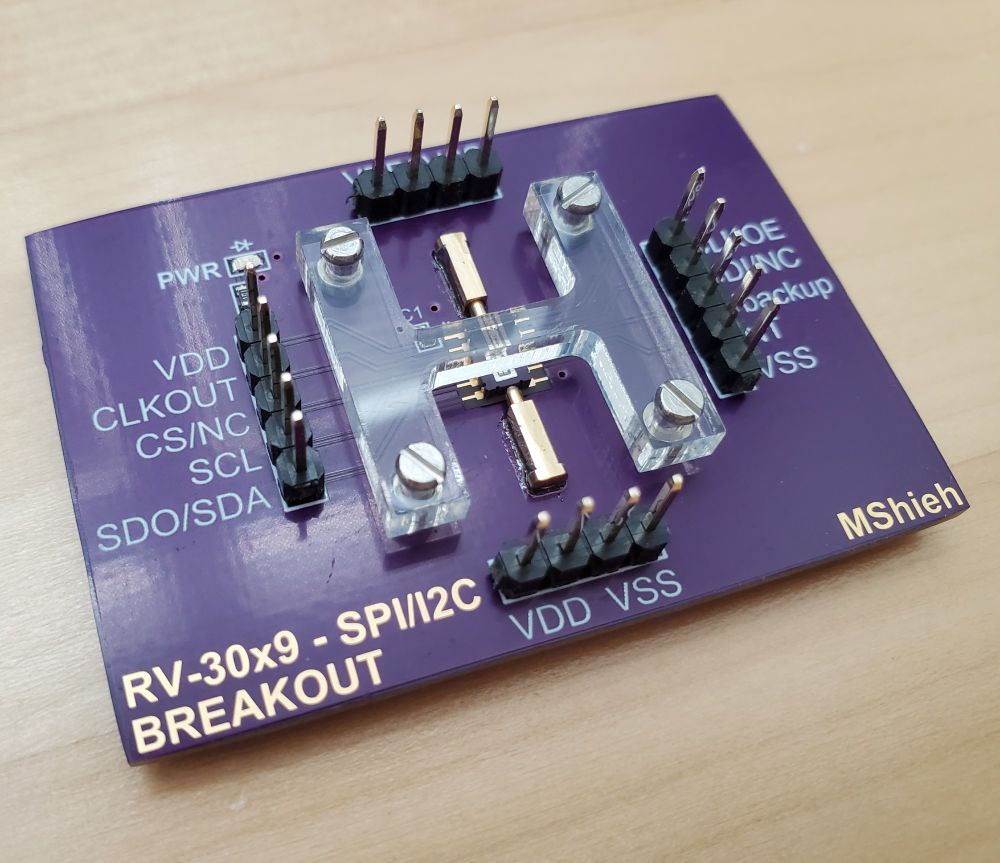 The acrylic cover pushes down on the IC so that its pads make contact with the board's pads.