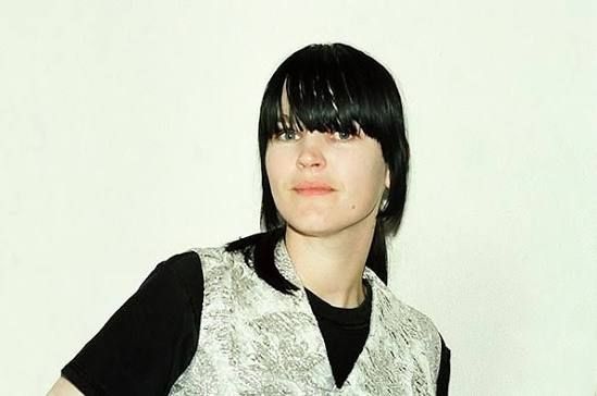 Photo of Trish Keenan from Broadcast. Her dark hair is in bangs nearly covering her eyes.
