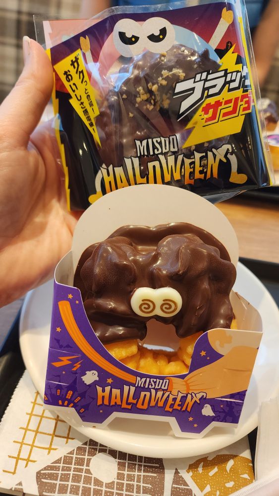 2 donuts with Halloween packaging and decor 