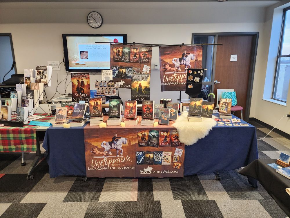 Author table showing many books and swag