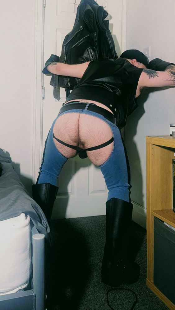Leatherman in denim chaps and Wesco harness boots.