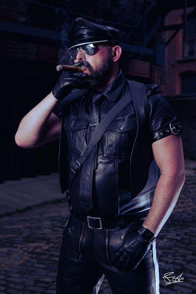 Leatherman in full BLUF smoking cigar.