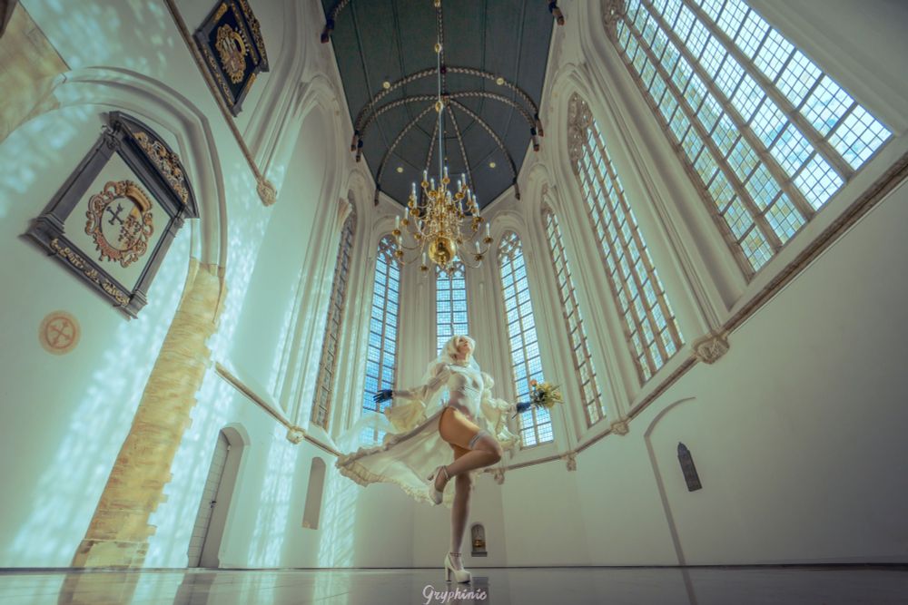 a cosplayer in a 2b wedding outfit twirling in a church, hit by ethereal lighting