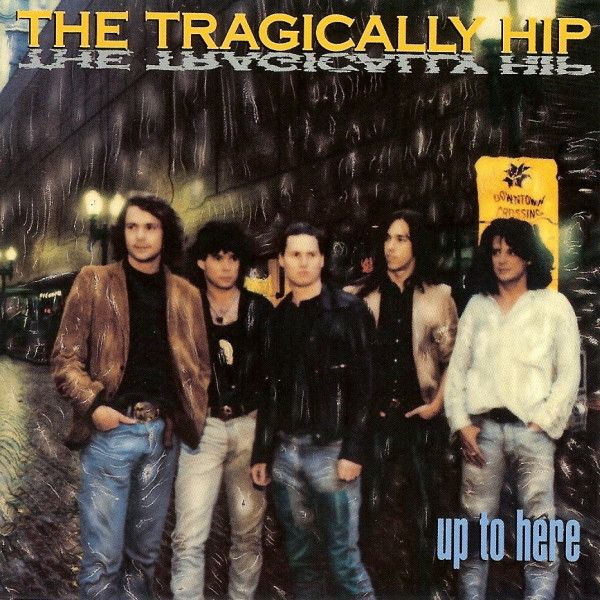 The cover of the 1989 Tragically Hip album Up To Here - all five members of the band standing in the street in the rain