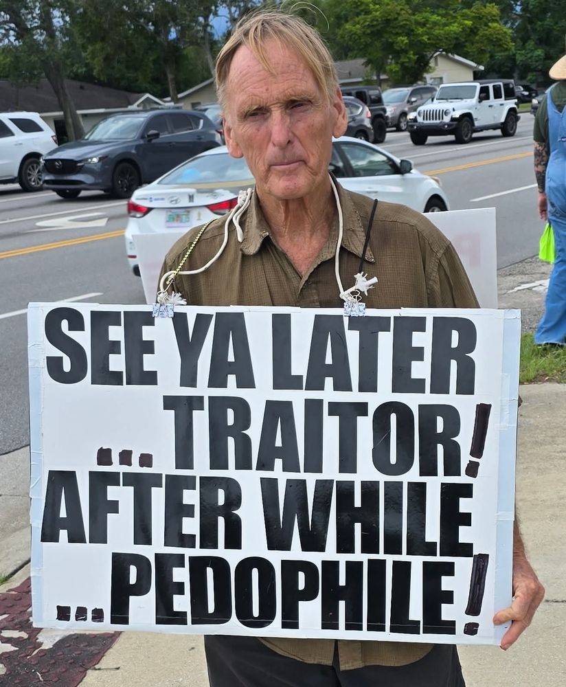See ya later traitor! After while pedophile! On a protest sign a man is holding. 