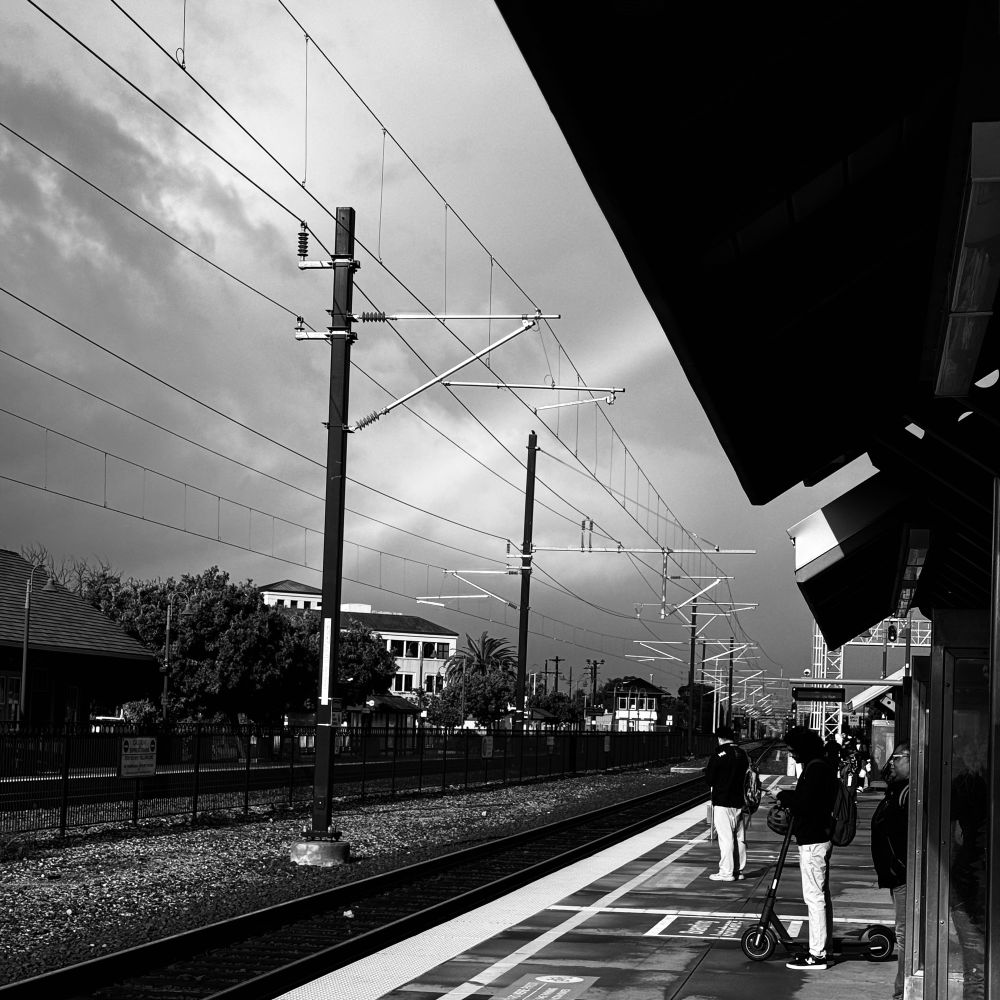 waiting for caltrain, it is cloudy and there is a rainbow