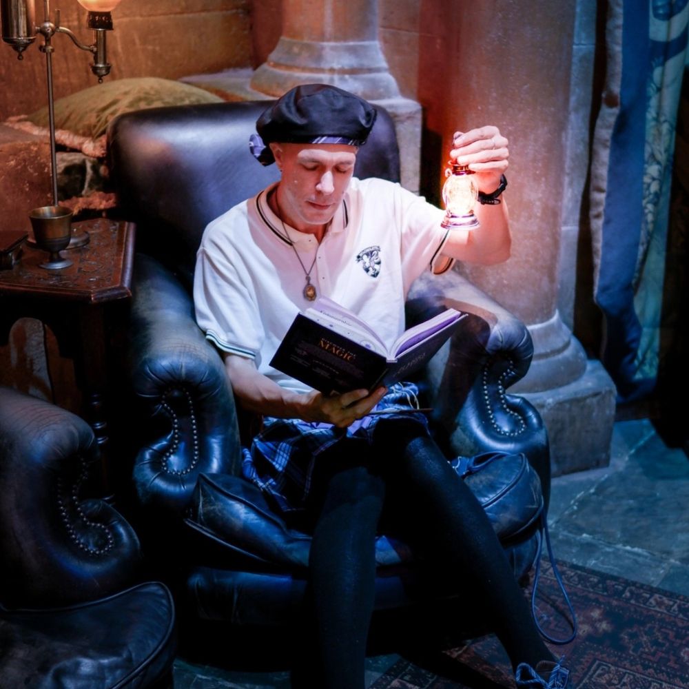 a guy sitting on a armchair with a little lantern in the hand at the Warner Bros Studio Tour Tokyo 