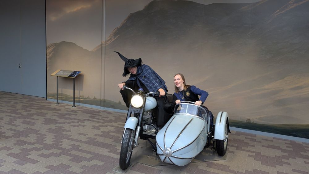 A couple dressed in ravenclaw cosplay sitting in Hagrids Motorcycle from the Harry Potter movies. Captured at the Warner Bros Studio Tour Tokyo 