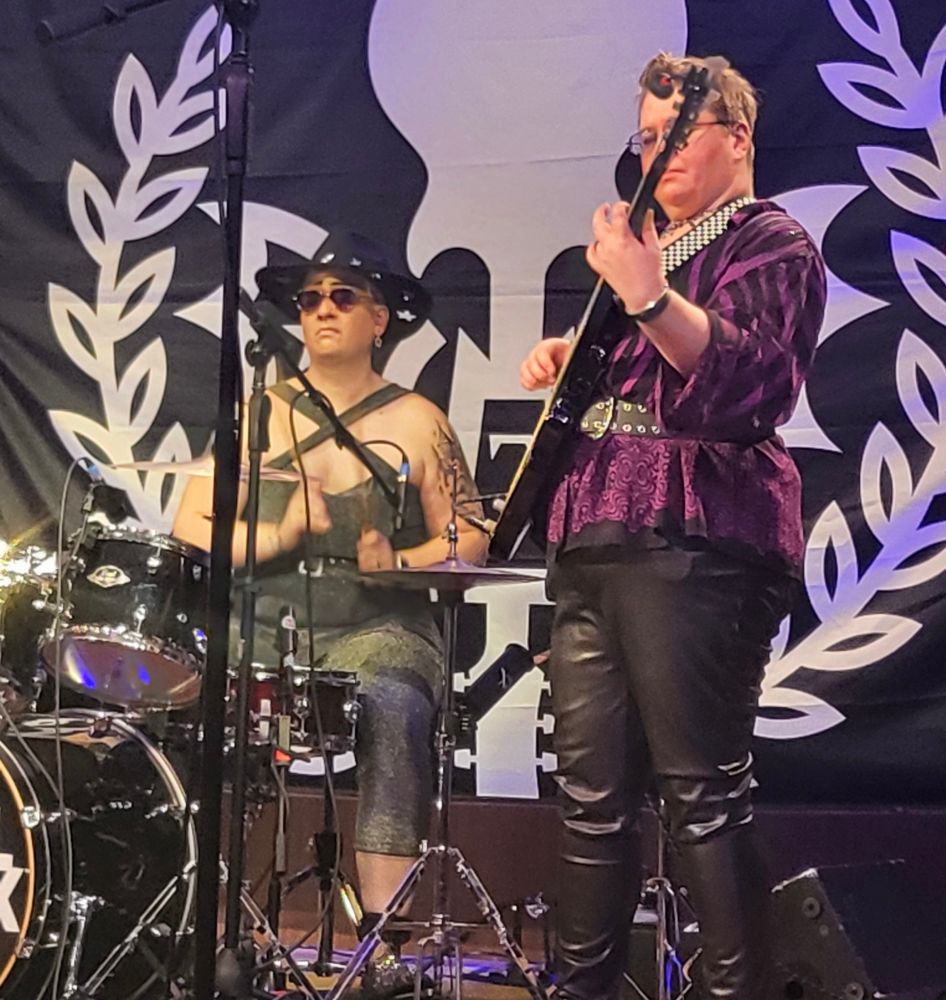 Me playing bass and my wife playing drums on stage! We look cool ok 