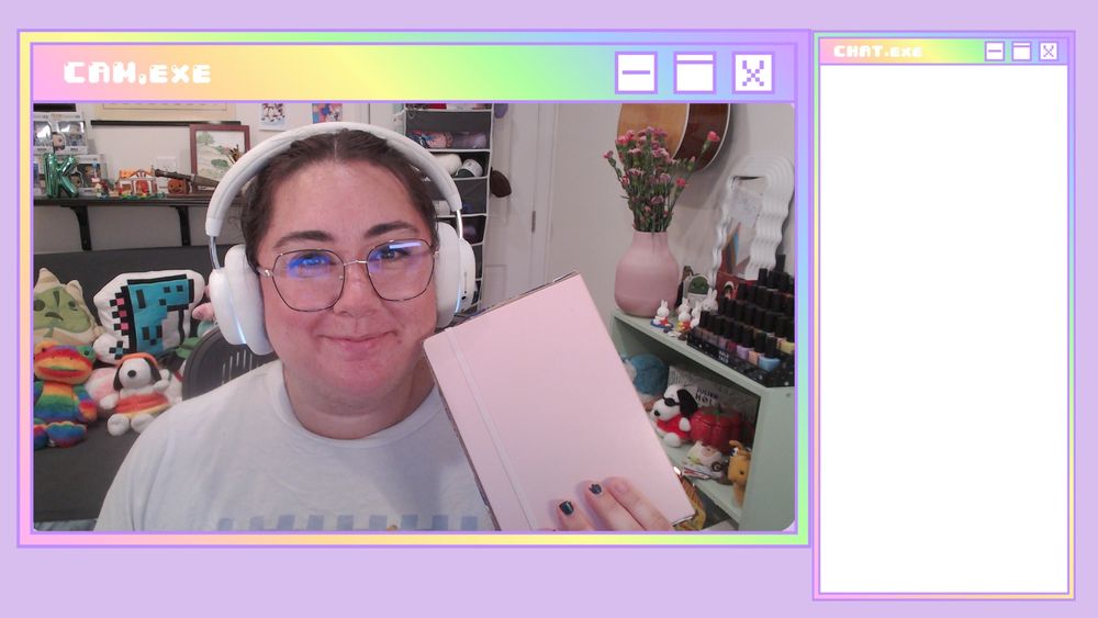 a photo of katelyn. they are wearing glasses and white headphones. She is also holding a pink journal. 
