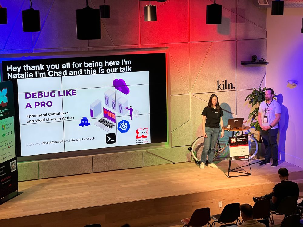 Two people giving a tech talk about debugging containers 