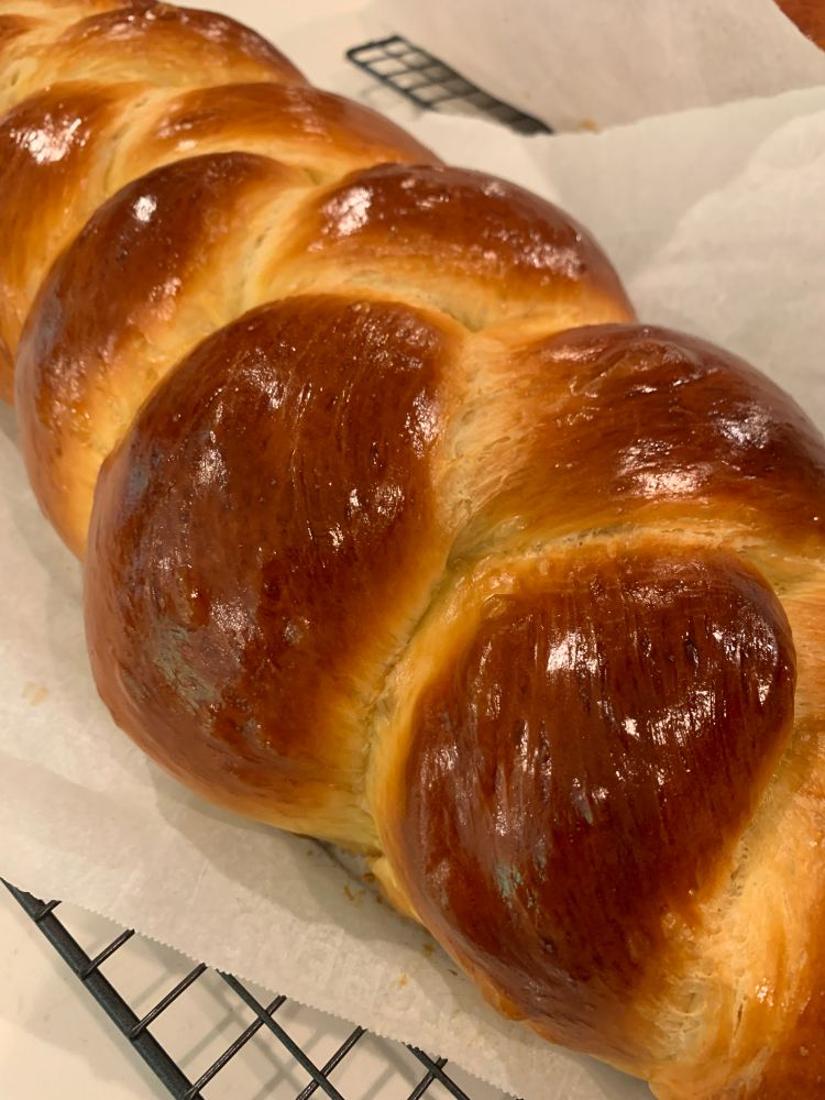 a shiny, freshly baked challah.