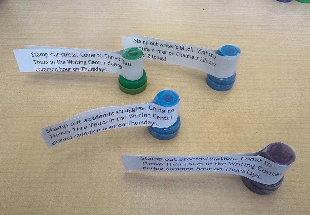 The image shows different stamps that read things like “stamp out writers block,” procrastination, stress, etc. and come to thrive thru Thursday.