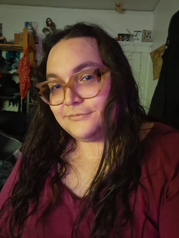 Selfie of Dona in her room in her magenta top. 