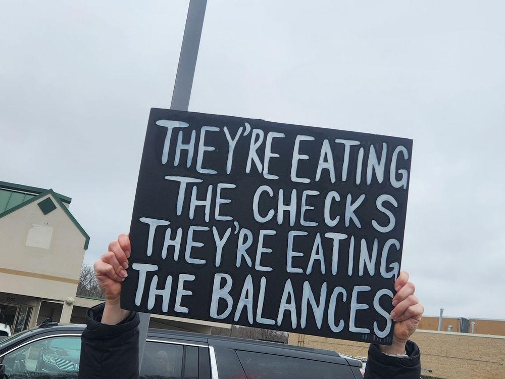 White text on black background reads "they're eating the checks,  they're eating the balances"