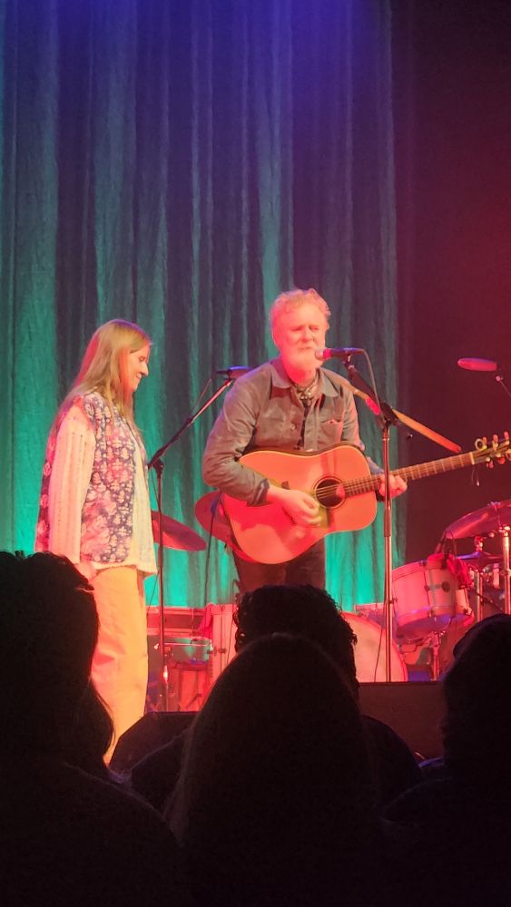 Markéta Irglová and Glen Hansard are lot by rainbow stage lights at the Fillmore in Detroit. And it is increasingly clear that I need a new cell phone because this photo is needlessly blurry despite having really excellent seats