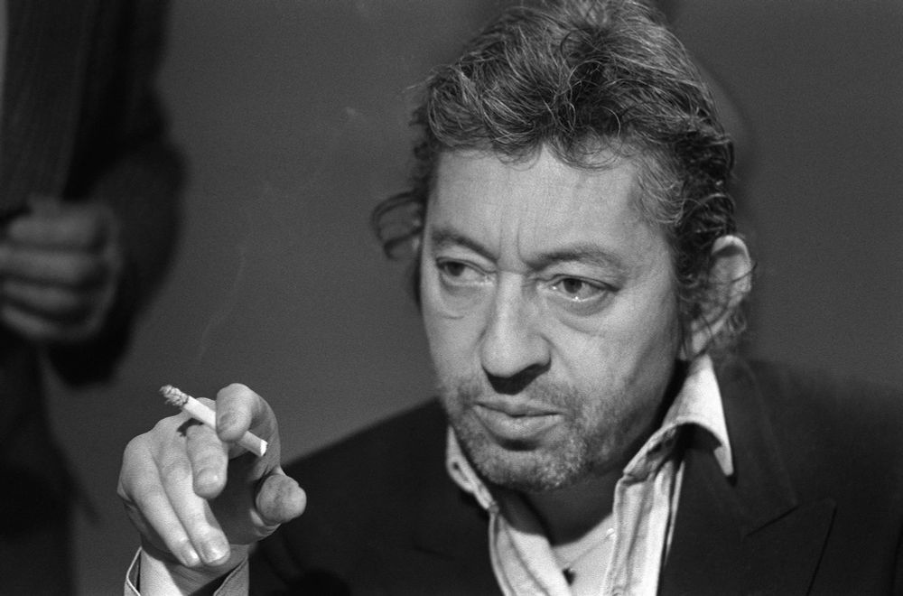 Serge Gainsbourg smokes and looks sad