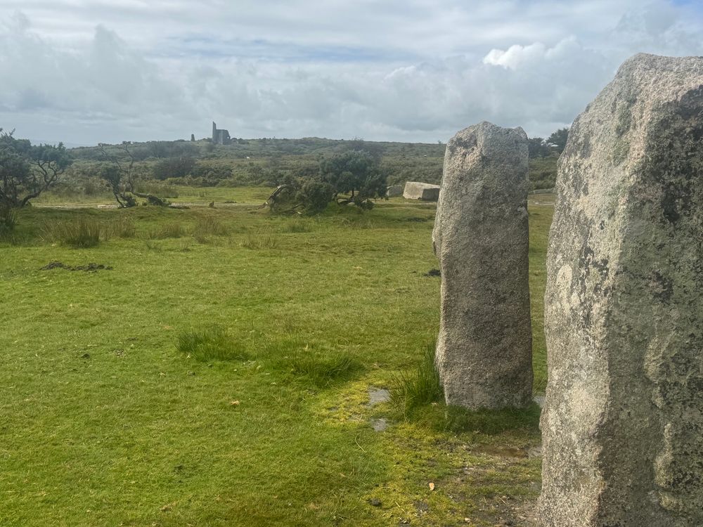Standing stones ‘The Hurlers’, in front of abandoned tin mine buildings