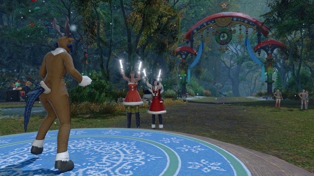 A screenshot of the video game FFXIV. It depicts a xaela in a reindeer suit in the forefront, with two holiday dressed friends that are a miqo'te and viera cheering the xaela on. It is located in the holiday event zone for this year.