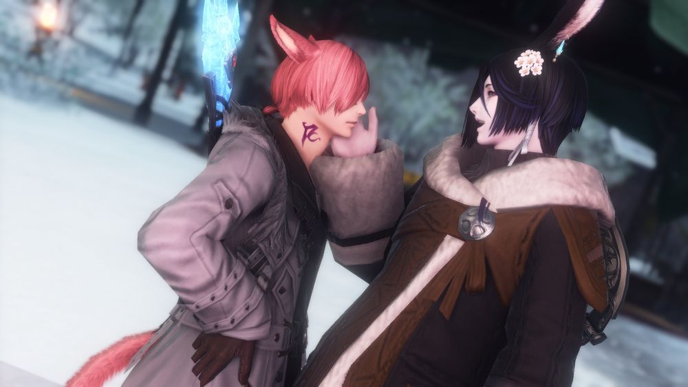 A screenshot of the game FFXIV. It depicts the character G'raha Tia and a black haired Viera exchanging a moment of affection in Garlean. They are both wearing warmer clothing for the snowier climate, and the Viera has their hand rested on G'raha's cheek.