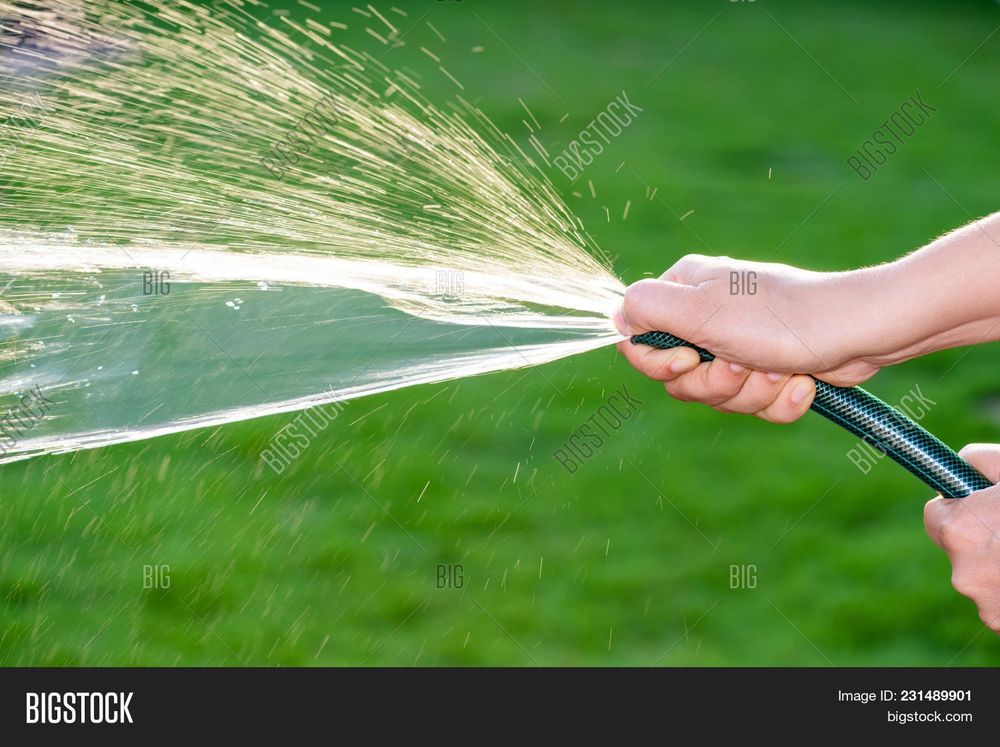 Stock image of someone putting their finger over the hose end to make the water shoot weird