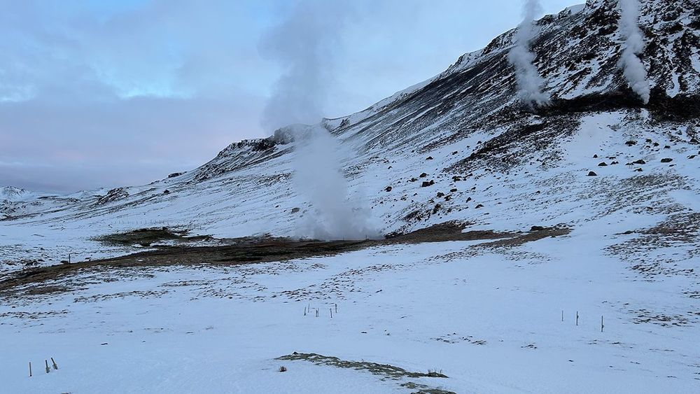 White plumes rise from an icy landscape.
