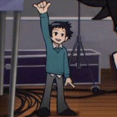 a cartoon boy is standing in front of a microphone with his hand up .