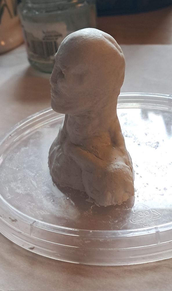 clay bust sculpture which is slightly skeletal in appearance, side view