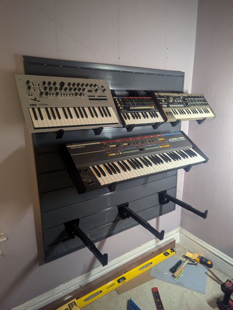 Synthesizers mounted on slatwall 