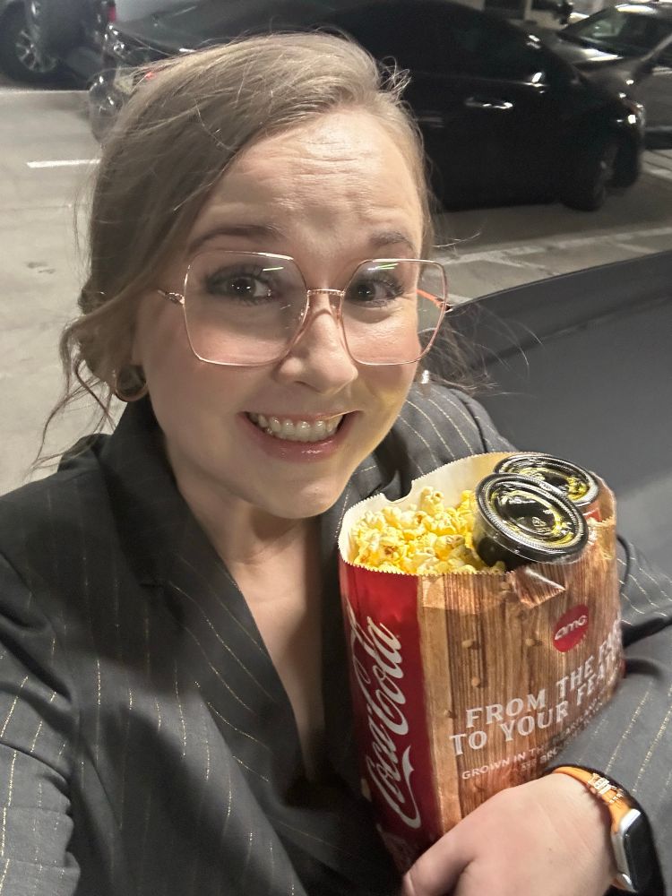 Me dressed as Nicole Kidman holding a bag of amc popcorn 