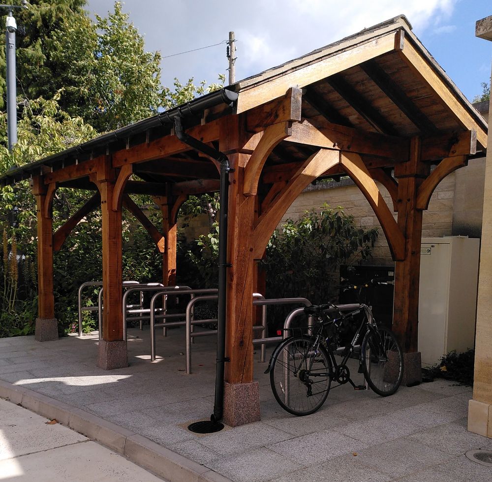 Sheffield stand bike parking with impressive wood frame shelter at Oxford Islamic centre