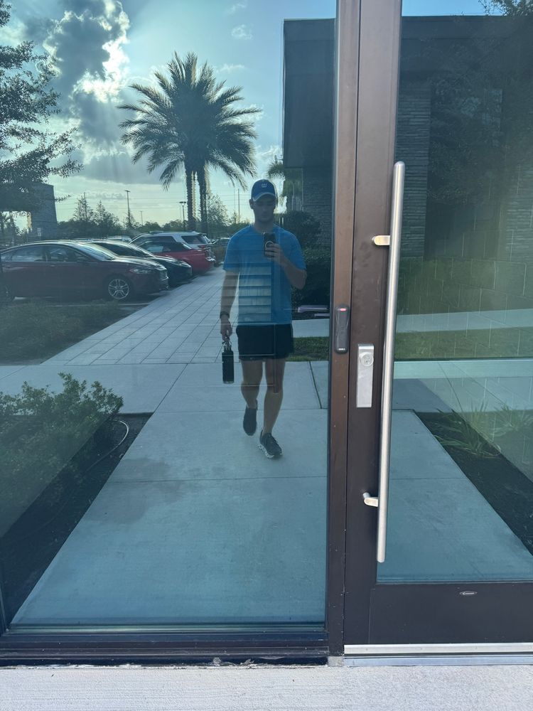 reflection of me in a window as I walk home sweaty from the gym