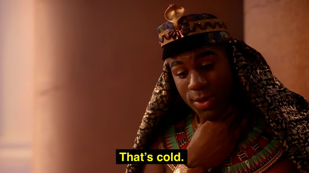 A Black man (Magic Johnson) wearing Ancient Egyptian clothing, looking down with his hand to his neck. The caption says "that's cold" (this is because someone just had his head chopped off for not entertaining the queen in the video for Michael Jackson's Remember The Time)