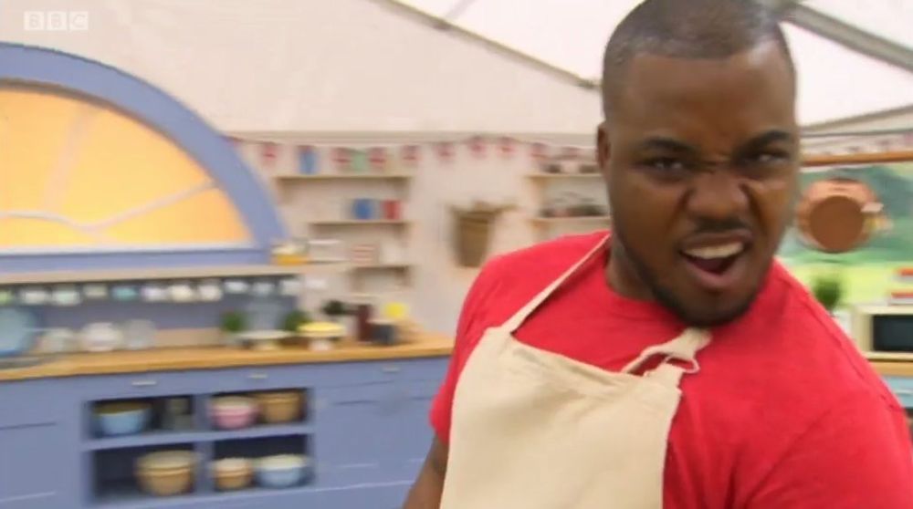 a Black man in an apron with an open-mouthed expression that, to me, says "oh yeah"