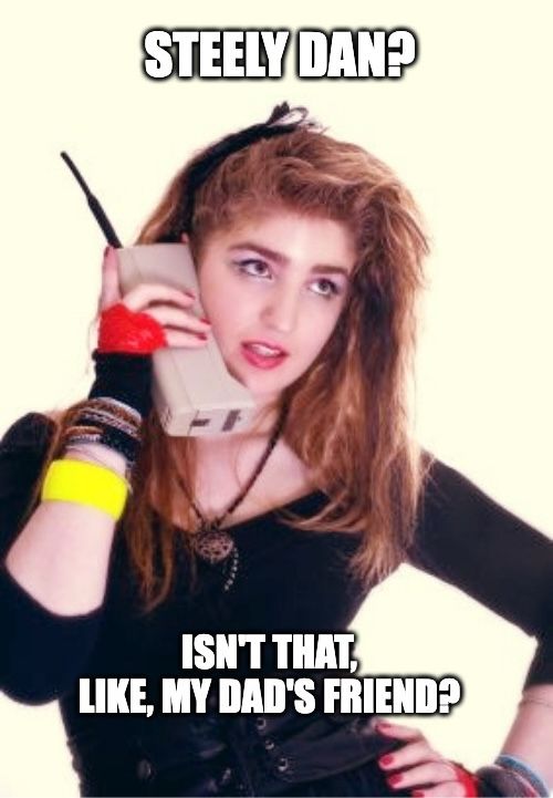 (Generated by ChatGPT) A meme showing a teenage girl dressed in 1980s fashion, holding a large vintage cell phone to her ear. The top text says: “STEELY DAN?” and the bottom text says: “ISN’T THAT, LIKE, MY DAD’S FRIEND?”