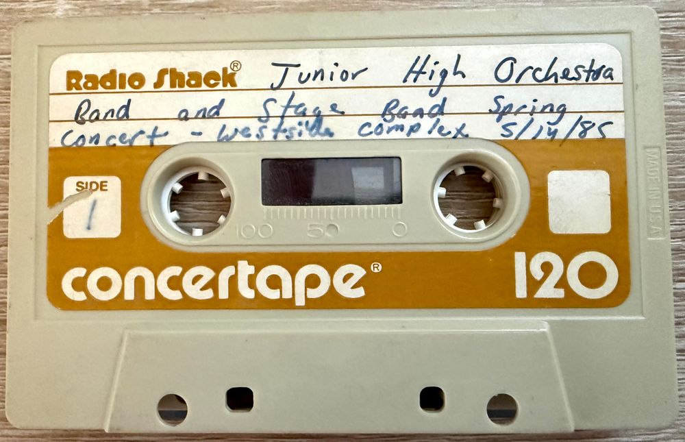 Photo of Radio Shack Concertape 120 cassette. Label reads "Junior High Orchestra Band and Stage Band Spring Concert - Westside Complex 5/14/85"