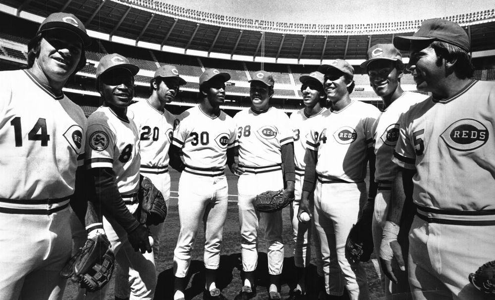 Image shows the Cincinnatti Reds "Big Red Machine" lineup in 3 Rivers Stadium. From left to right: Pete Rose, Joe Morgan, Cesar Geronimo, Ken Griffey Sr., pitcher Gary Nolan, David Concepcion, Tony Perez, George Foster and Johnny Bench.