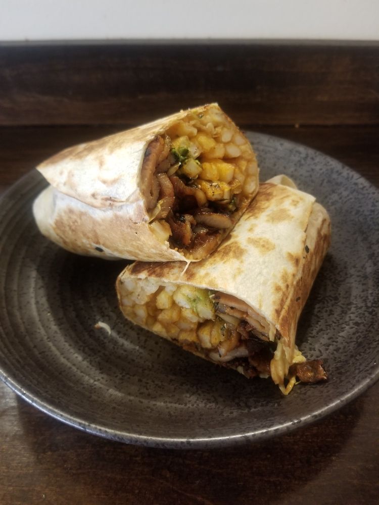 Wrap with spicy pork, onion, green onion, cabbage, fries, avocado, spicy dressing, and furikake
