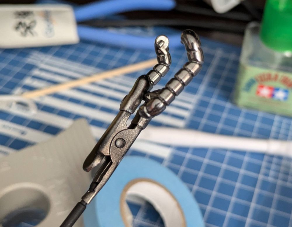 A piece of Zaku tubing from the SDCS Zaku gunpla, painted chrome.