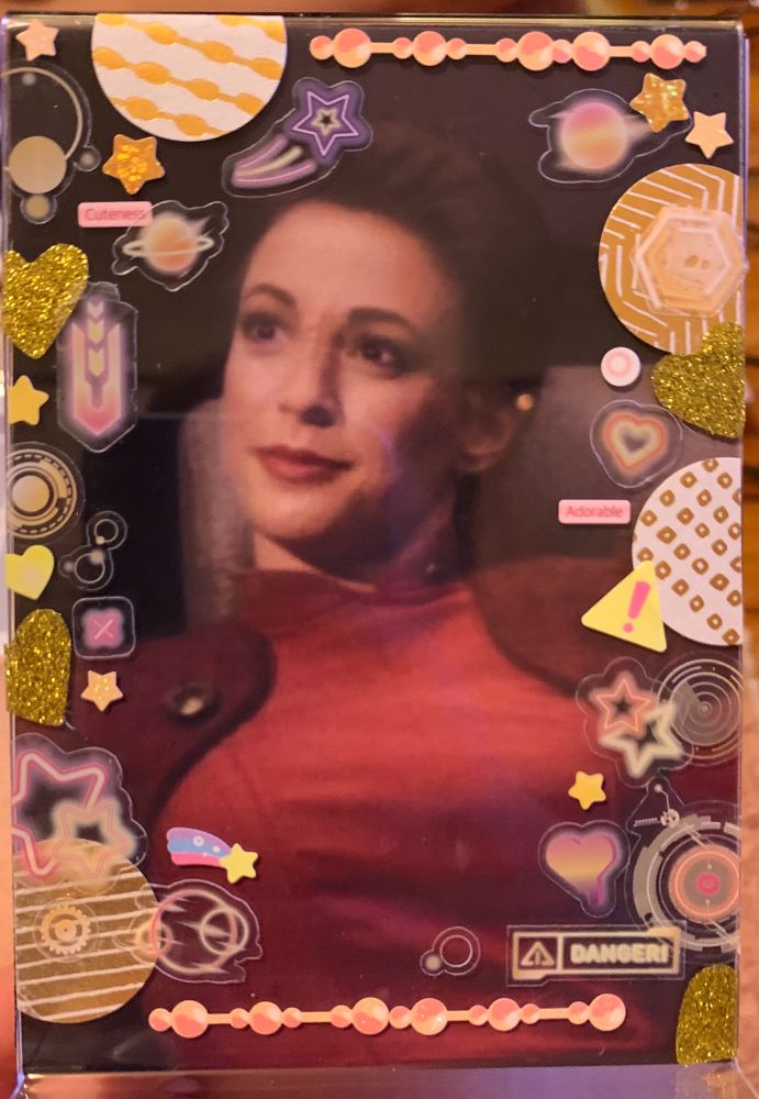 A printed image of Kira Nerys from Star Trek: Deep Space Nine decorated with stickers. 
